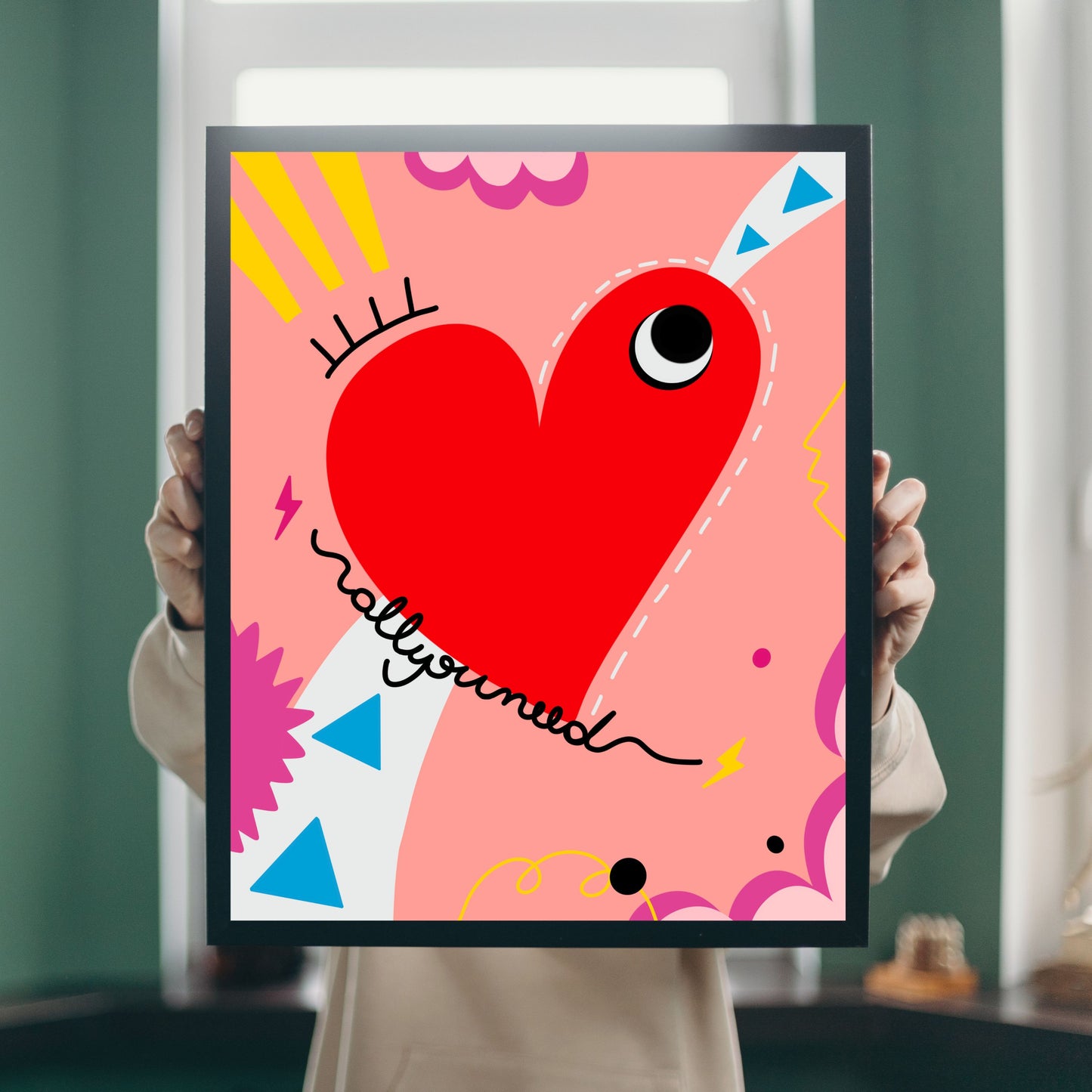 All You Need art print with an original drawing of a quirky red heart with one big eye, colorful background, adding a touch of whimsy and joy to any space.