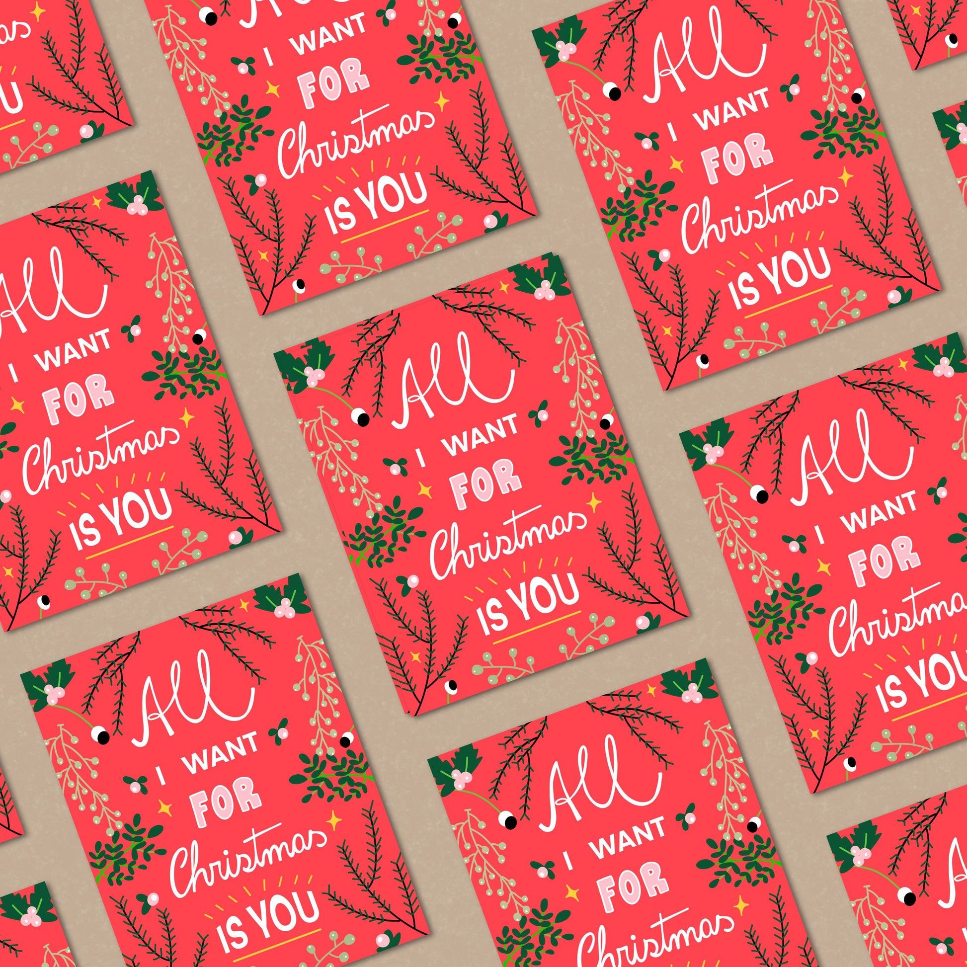 Christmas greeting card with the phrase All I Want For Christmas Is You on a red background with greenery on the borders. Perfect for expressing love and holiday cheer with joy and charm.