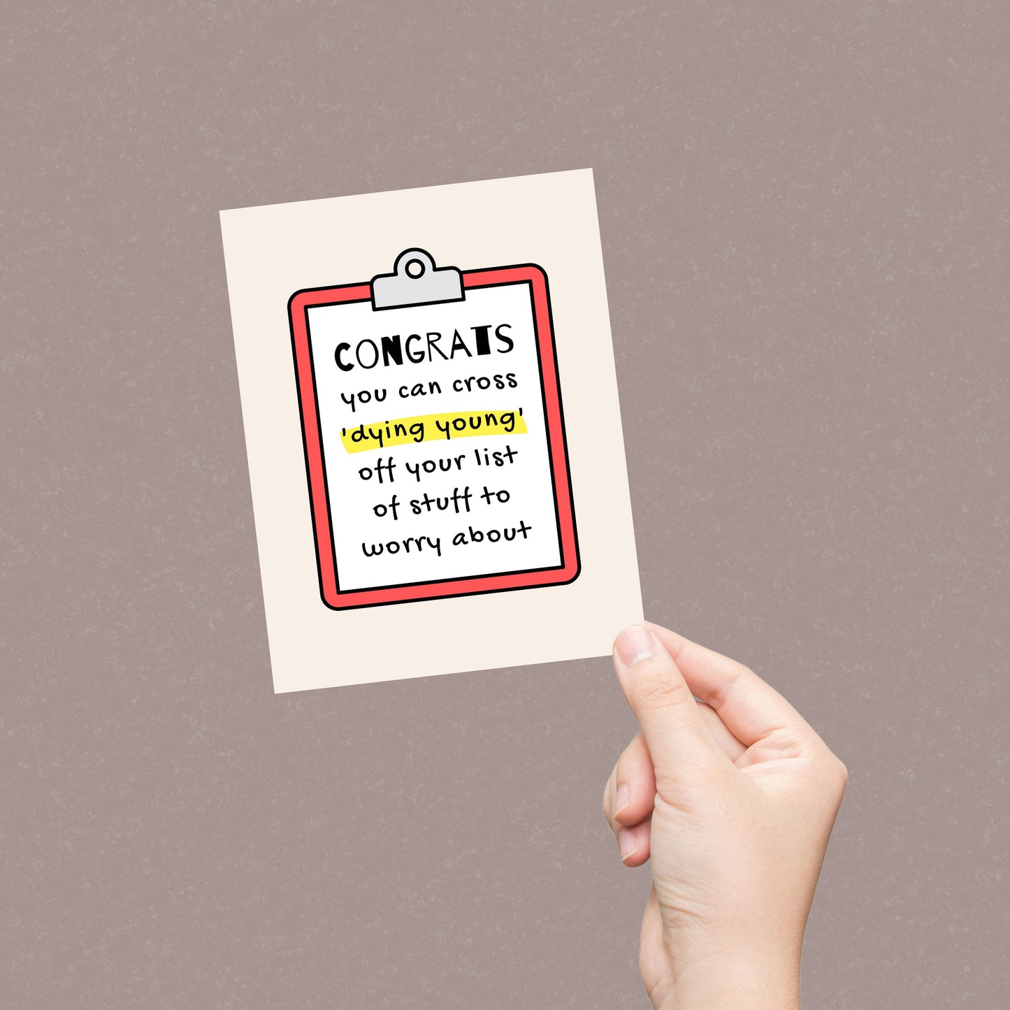 Humorous birthday card with a clipboard design and the phrase Congrats you can cross dying young off your list of stuff to worry about. Perfect for a funny and light-hearted birthday message, ideal for friends or family members with a sense of humor.