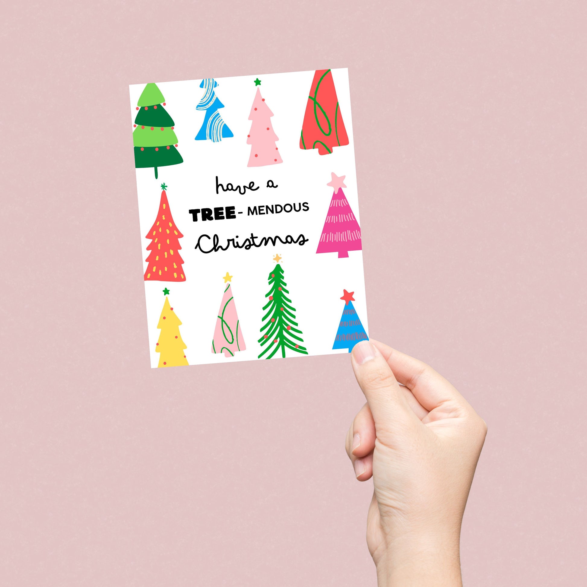 Have a Tree-mendous Christmas greeting card featuring a playful design of colorful Christmas trees and a festive phrase, perfect for spreading holiday cheer and sending fun, pun-filled holiday wishes to loved ones.