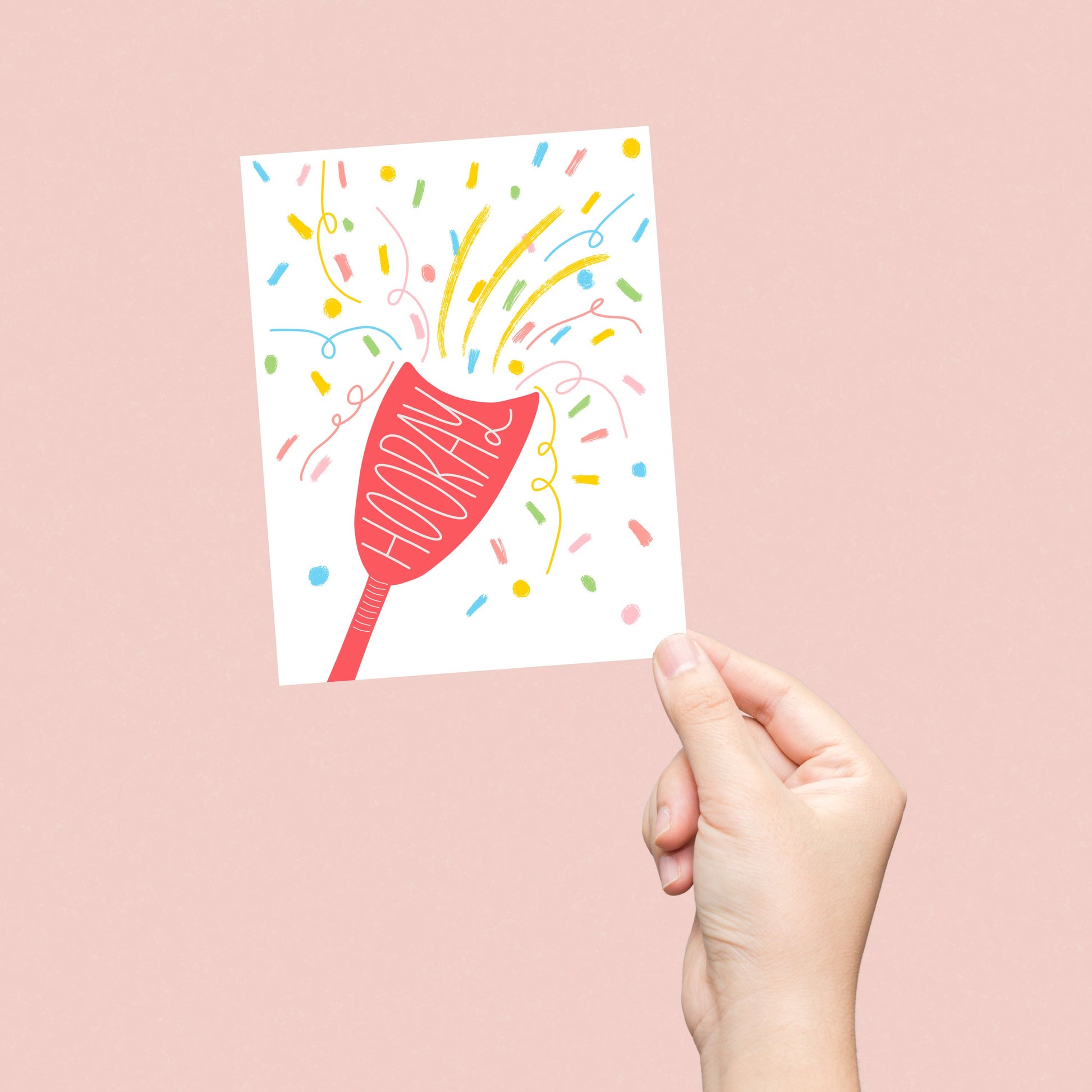 Greeting card with the word Hooray written in a party popper, featuring an original drawing of a party popper and colorful confetti flying out. Perfect for celebrating any joyous occasion with a festive and humorous touch.