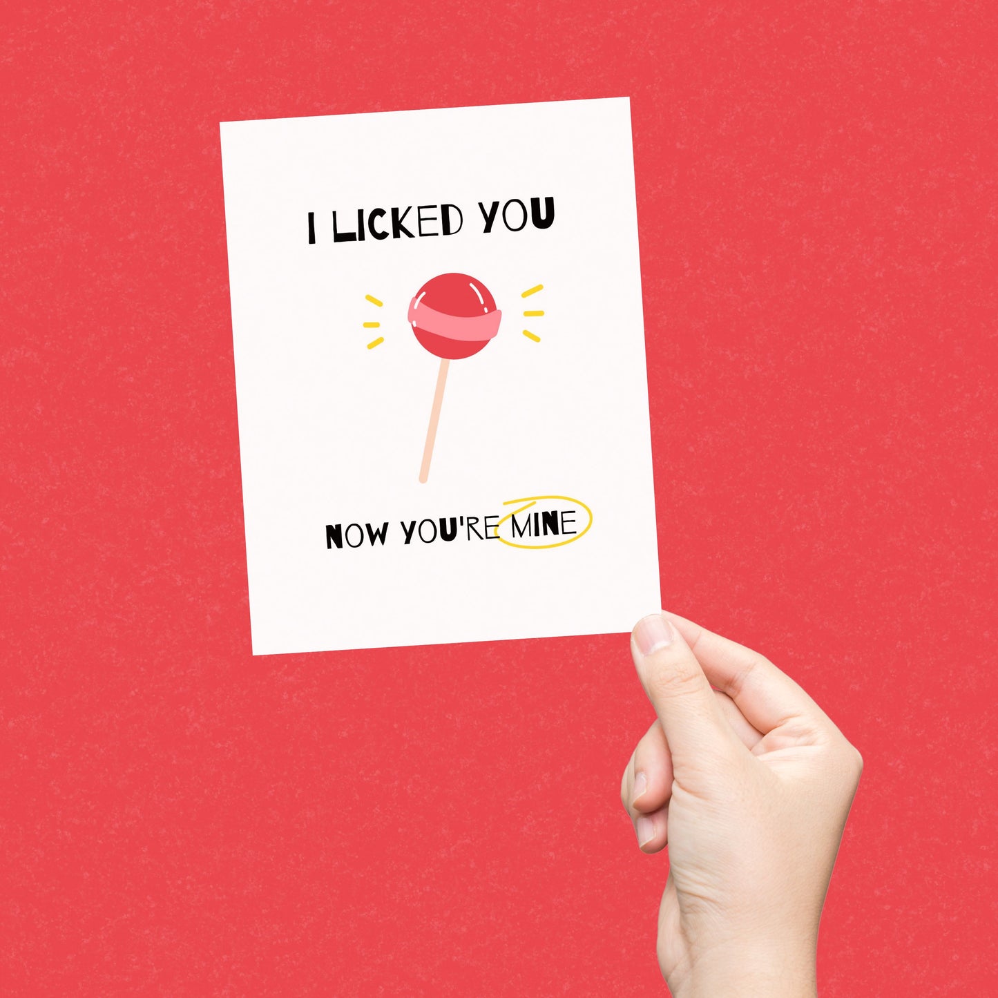 Greeting card with a red lollipop illustration and the funny phrase "I Licked You, Now You’re Mine." Perfect for expressing affection with humor.