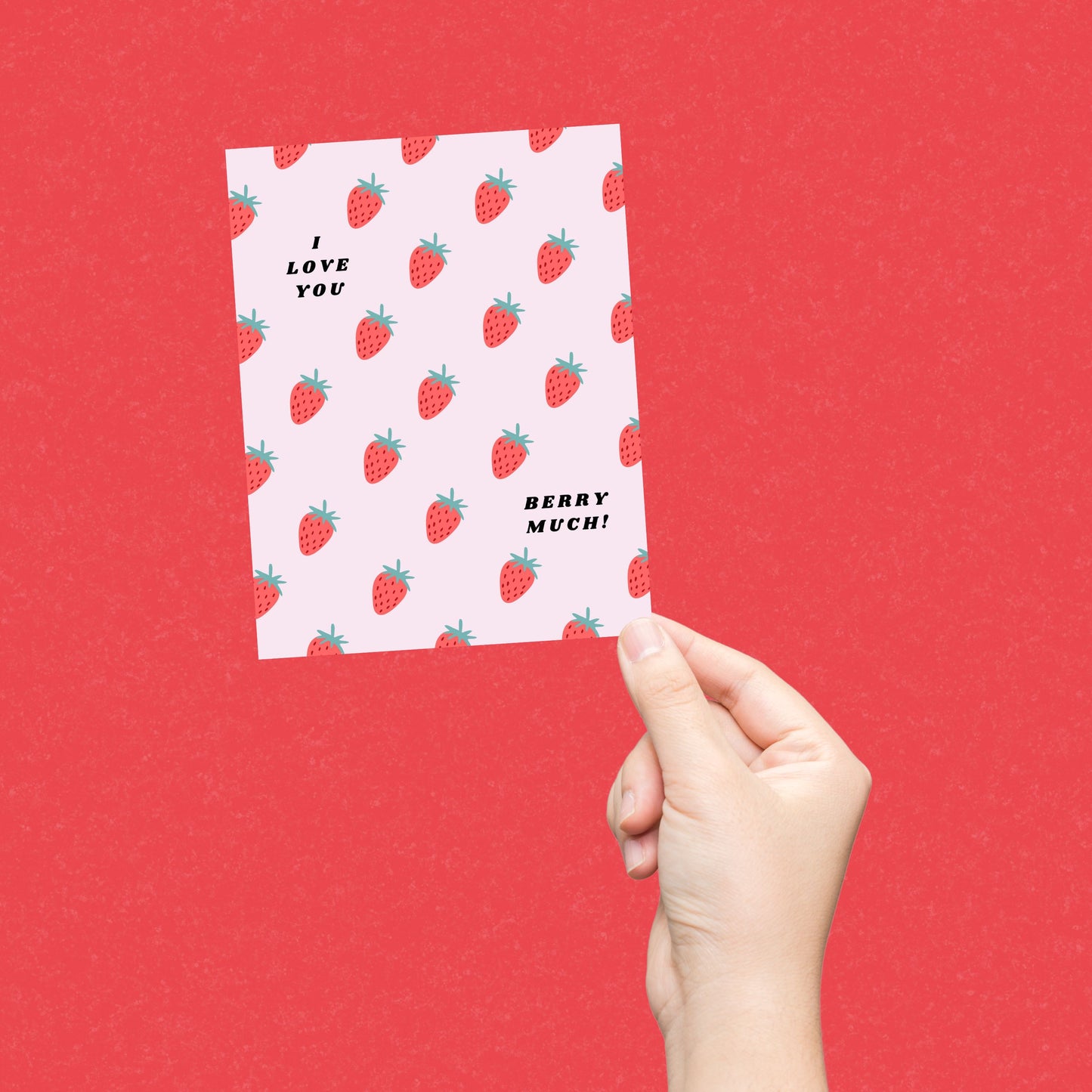 Greeting card with the phrase I Love You Berry Much on a pink background filled with little strawberries. Perfect for expressing love and appreciation with humor and charm.