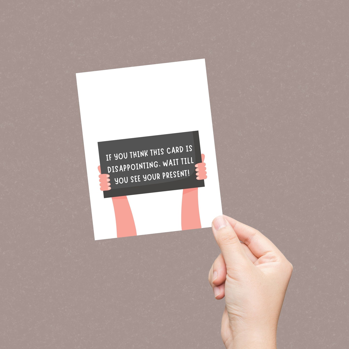 Funny greeting card with two illustrated arms holding a sign that reads If You Think This Card Is Disappointing, Wait Till You See Your Present. Perfect for adding humor to birthdays, holidays, or any special occasion.