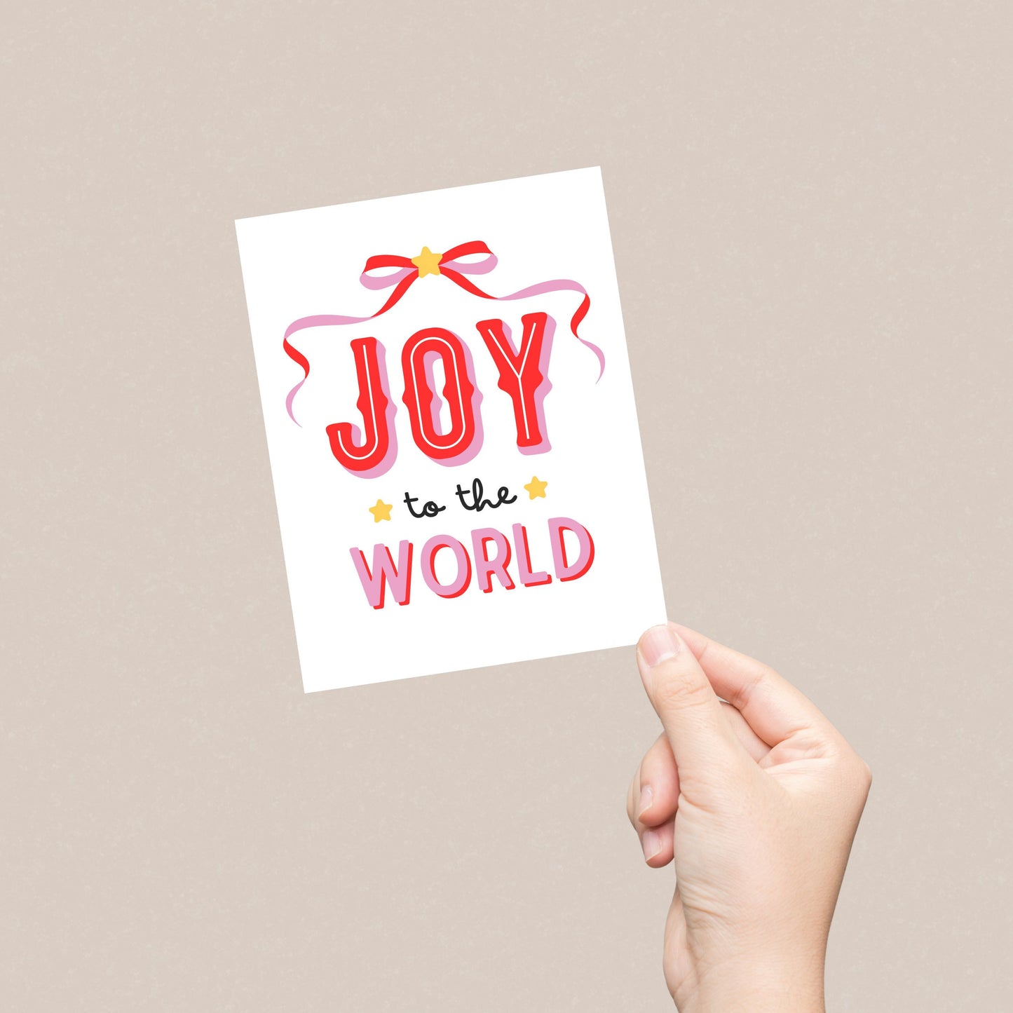 Christmas greeting card with a pink and red bow design, featuring the festive phrase Joy To The World in bold lettering, perfect for spreading holiday cheer with a fun and playful touch.