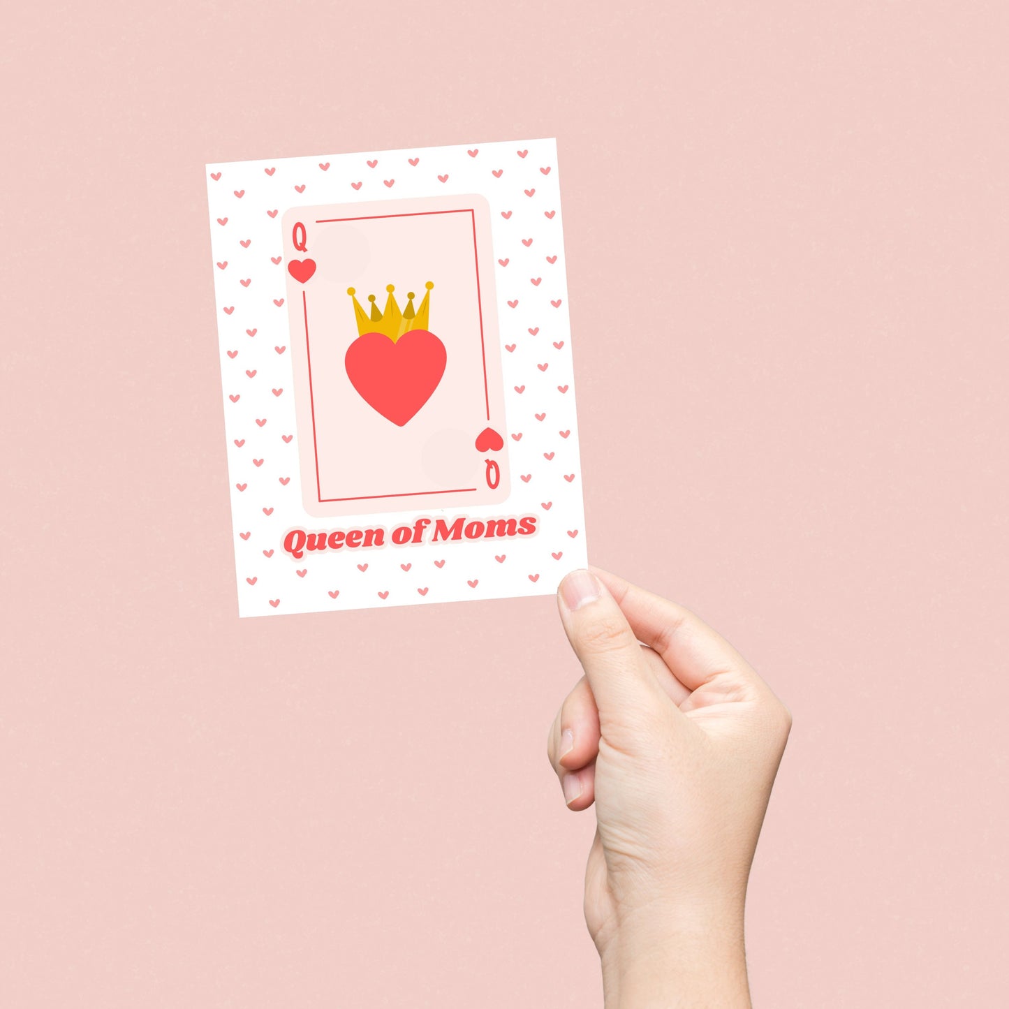 Queen of Moms greeting card featuring a Queen of Hearts playing card design with a crowned heart in the center and a background filled with small red hearts. Perfect for Mother's Day, birthdays, or just because.