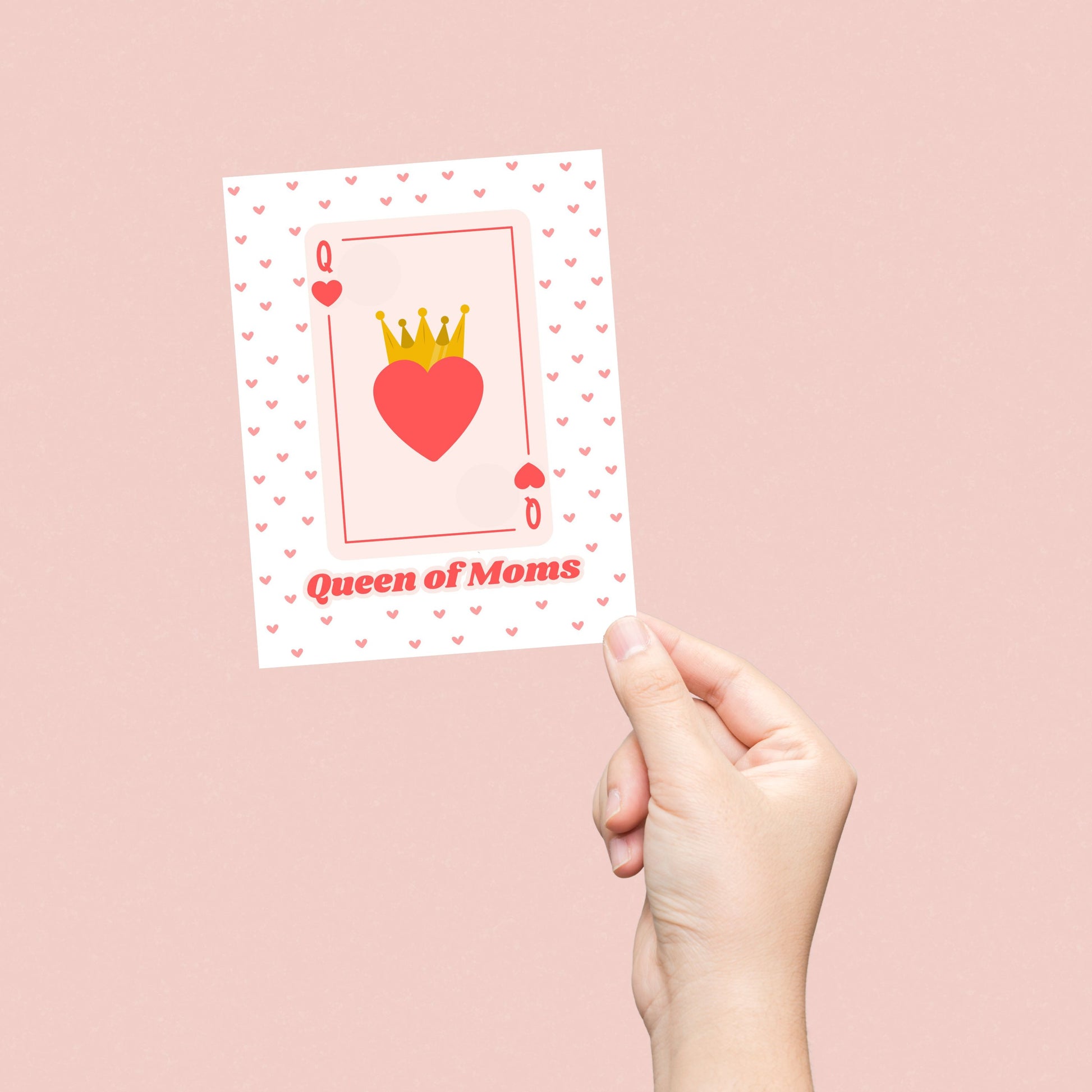 Queen of Moms greeting card featuring a Queen of Hearts playing card design with a crowned heart in the center and a background filled with small red hearts. Perfect for Mother's Day, birthdays, or just because.