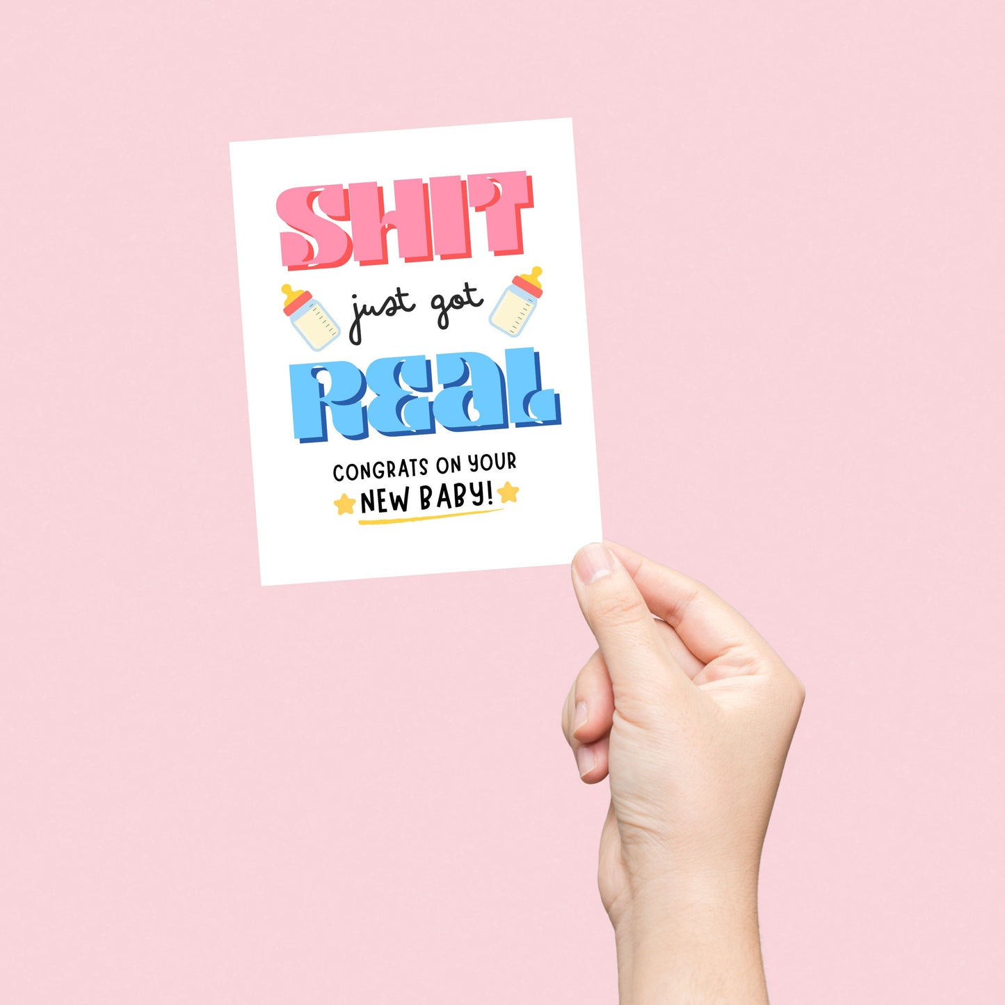 Funny new baby greeting card with bold letters, two baby bottles, and stars, featuring the phrase 'Sh*t Just Got Real Congrats On Your New Baby' for parents-to-be, baby showers, or newborn celebrations.