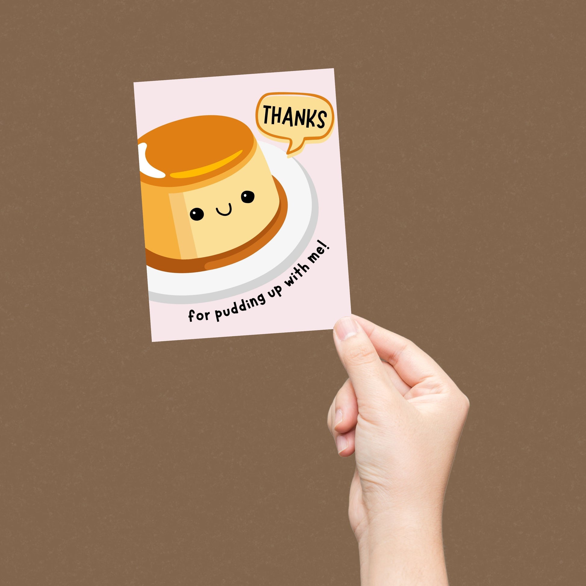Cute thank you greeting card with a smiling pudding illustration and the phrase "Thanks For Pudding Up With Me". Perfect pun card for friends, family, or coworkers to show appreciation, humor, and gratitude.