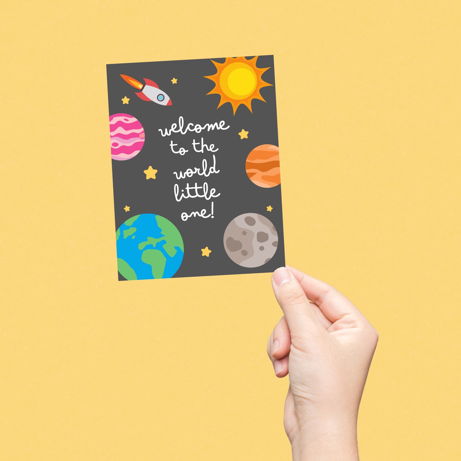 "Welcome to the World Little One" greeting card featuring cute hand-drawn planets and a rocket design, perfect for celebrating a newborn baby with a fun, space-themed touch. Ideal for baby showers, new parents, or welcoming a little astronaut.