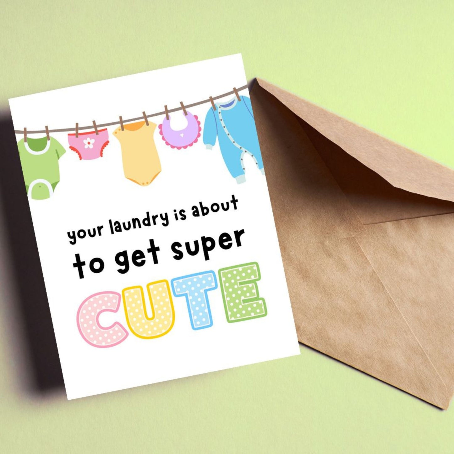 Funny new baby card with a clothesline full of cute baby clothes and the phrase "Your Laundry Is About To Get Super Cute," perfect for baby shower, pregnancy announcement, or new parent congratulations.