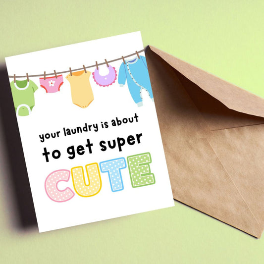 Funny new baby card with a clothesline full of cute baby clothes and the phrase "Your Laundry Is About To Get Super Cute," perfect for baby shower, pregnancy announcement, or new parent congratulations.