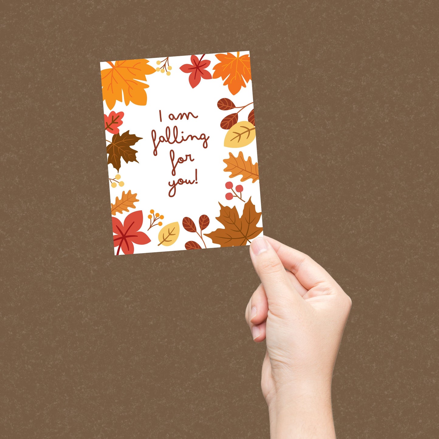 Greeting card with colorful fall leaves and the phrase 'I Am Falling For You' in bold letters. Perfect for expressing love and affection with a seasonal autumn theme. Ideal for romantic gestures or cozy fall greetings.