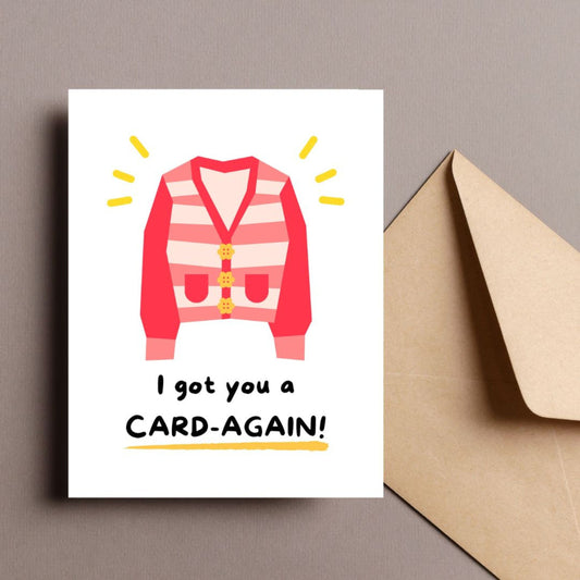 Cute greeting card featuring an illustration of a cozy cardigan with the punny phrase "I Got You A Card-Again." Perfect for birthdays, just-because moments, or to bring a smile with a clever play on words.