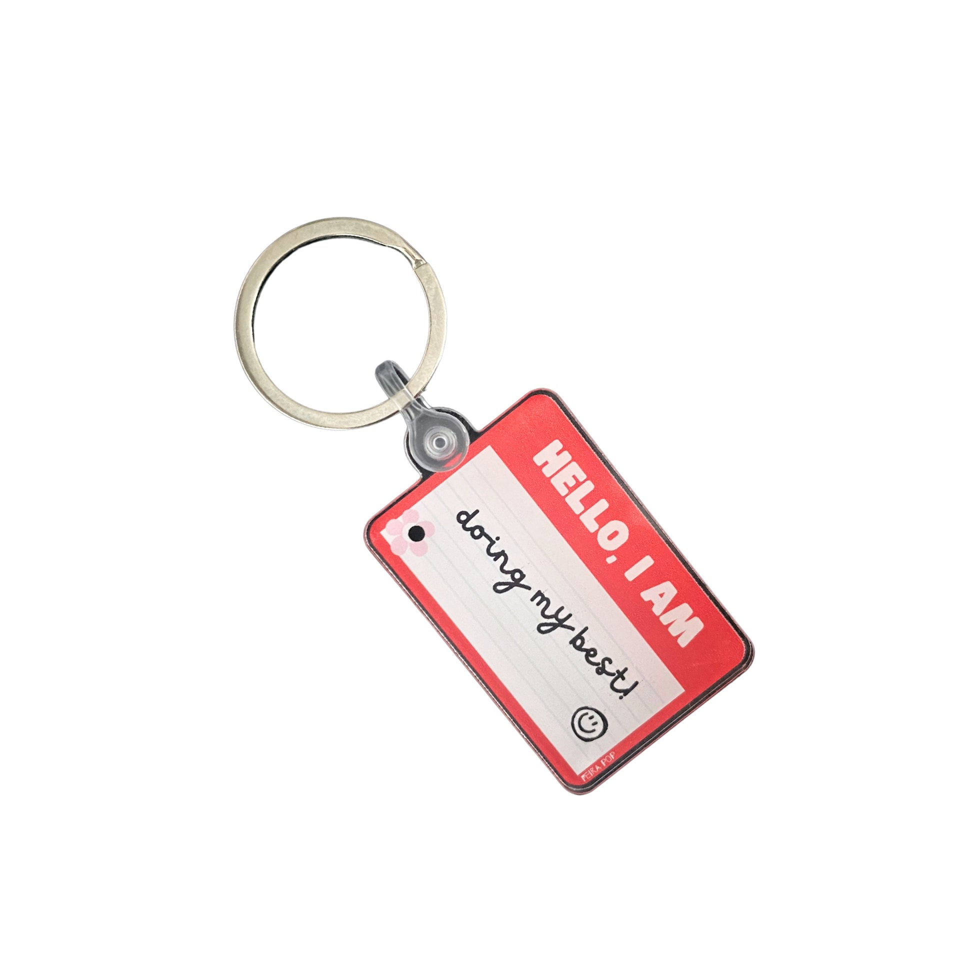 Red name tag keychain with the phrase Hello, I Am Doing My Best, humorous motivational accessory, perfect for daily encouragement and resilience, ideal gift for friends and family.