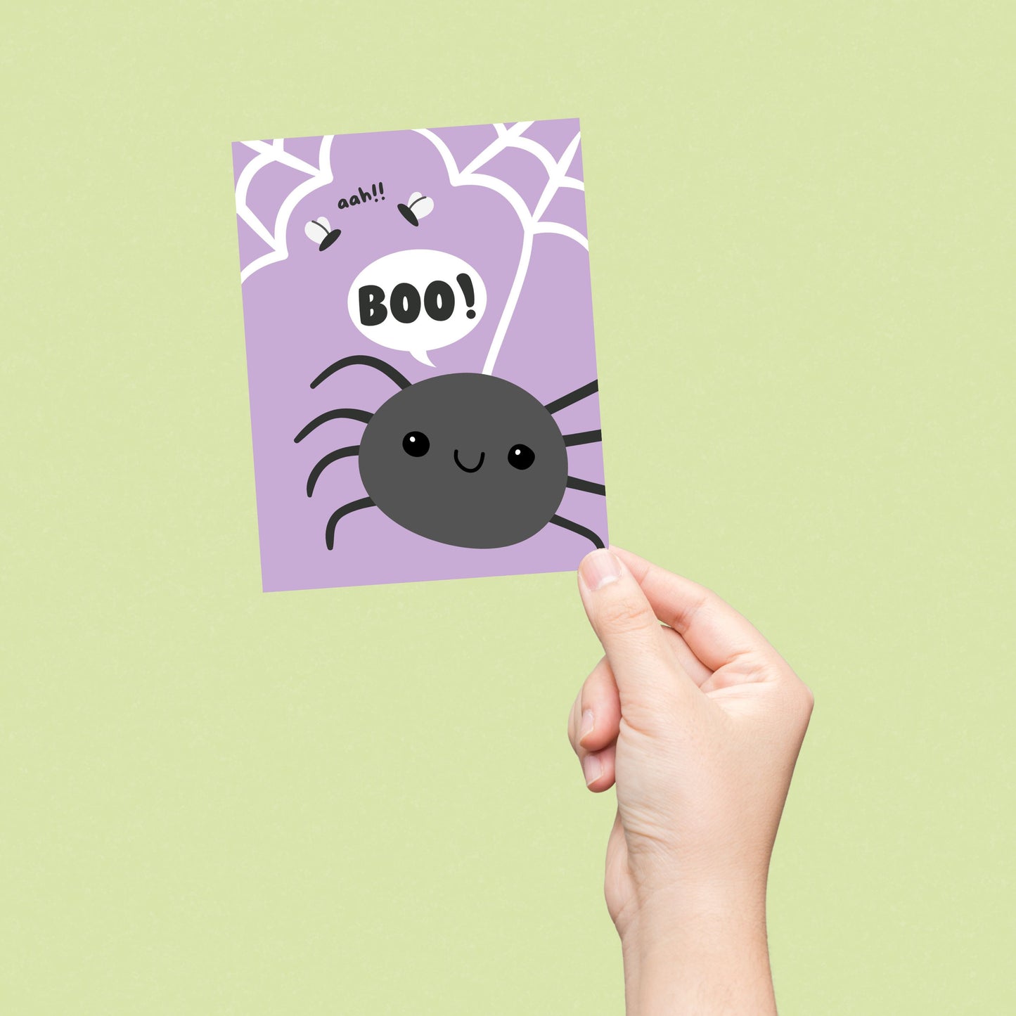 Halloween greeting card with a purple background filled with spider webs, a large black spider saying 'boo' in a speech bubble, and two scared flies exclaiming 'aah.' Funny and spooky design perfect for Halloween greetings.