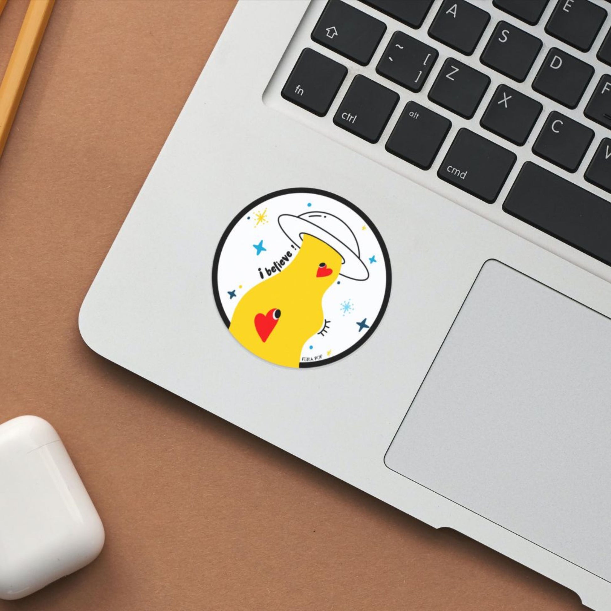 Sticker with the phrase I Believe featuring an original drawing of a UFO abducting two cute red hearts. Perfect for UFO enthusiasts and lovers of whimsical, romantic art.