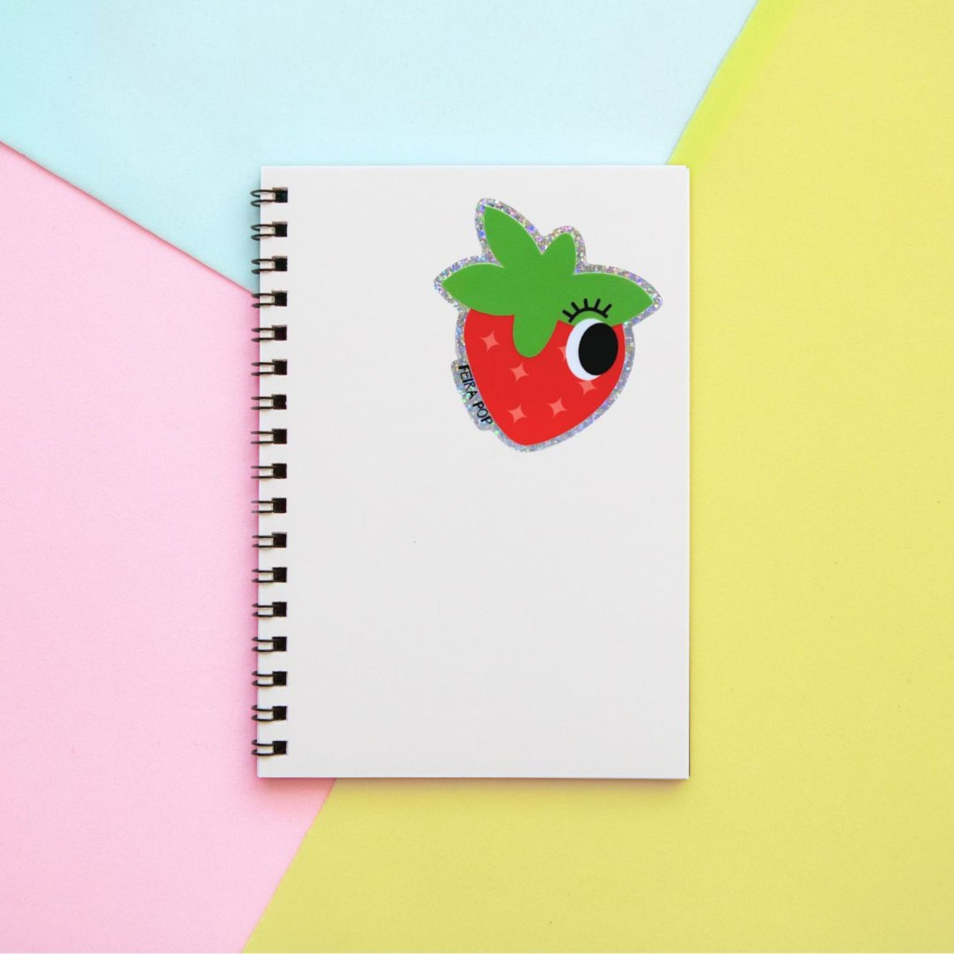 Glitter sticker with a cute strawberry drawing featuring one big eye, perfect for adding a playful and sparkly touch to your belongings.