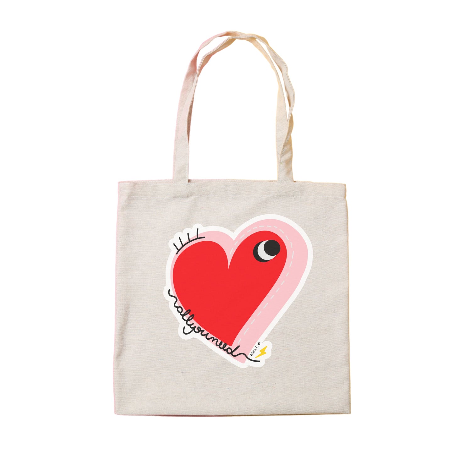 All You Need Tote Bag with original drawing of a big red heart with one eye and the words All You Need in playful font, perfect for carrying daily essentials and adding a touch of fun to any outfit.