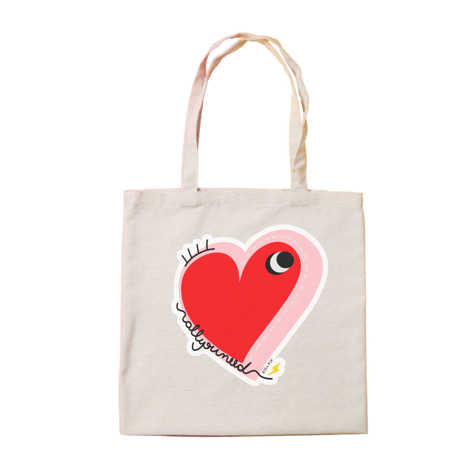 All You Need Tote Bag with original drawing of a big red heart with one eye and the words All You Need in playful font, perfect for carrying daily essentials and adding a touch of fun to any outfit.