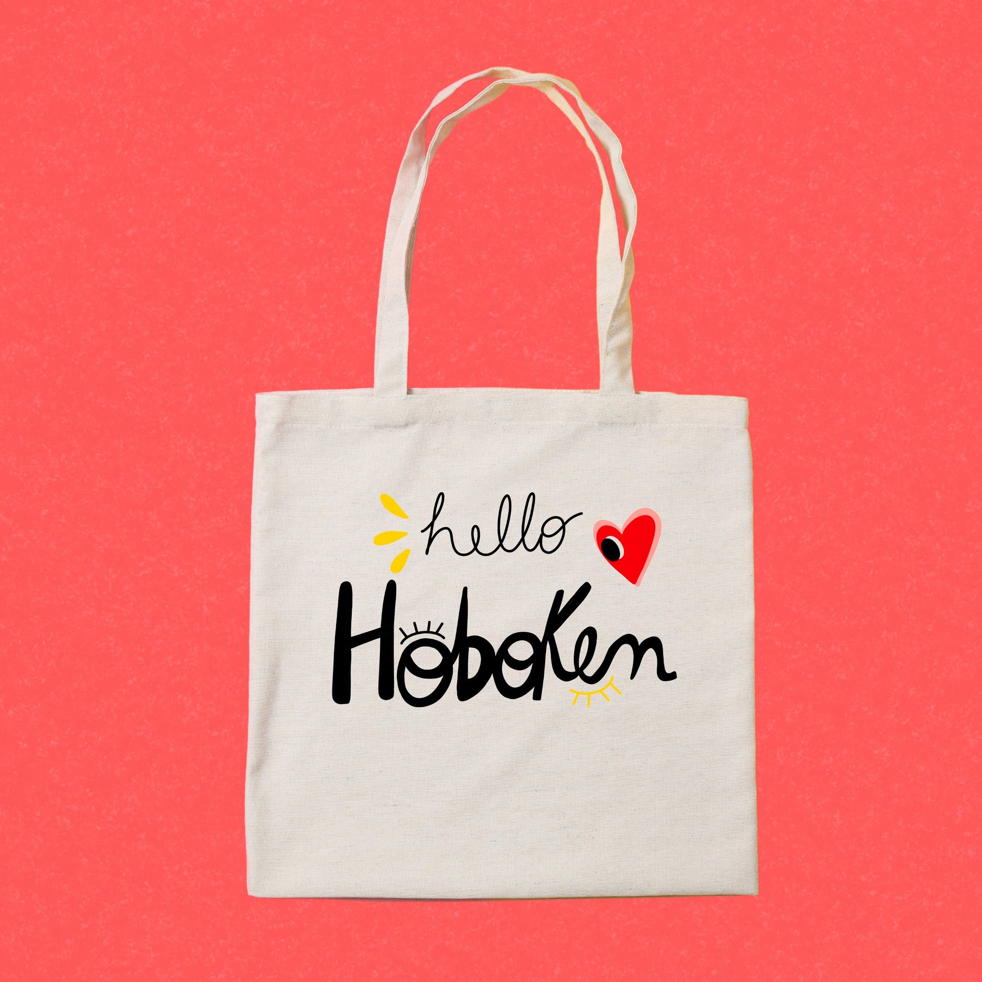 Tote bag with red heart and big eye design, called Hello Hoboken, representing Hoboken, New Jersey, perfect for stylish everyday use.