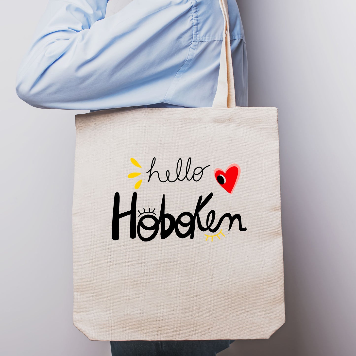 Tote bag with red heart and big eye design, called Hello Hoboken, representing Hoboken, New Jersey, perfect for stylish everyday use.