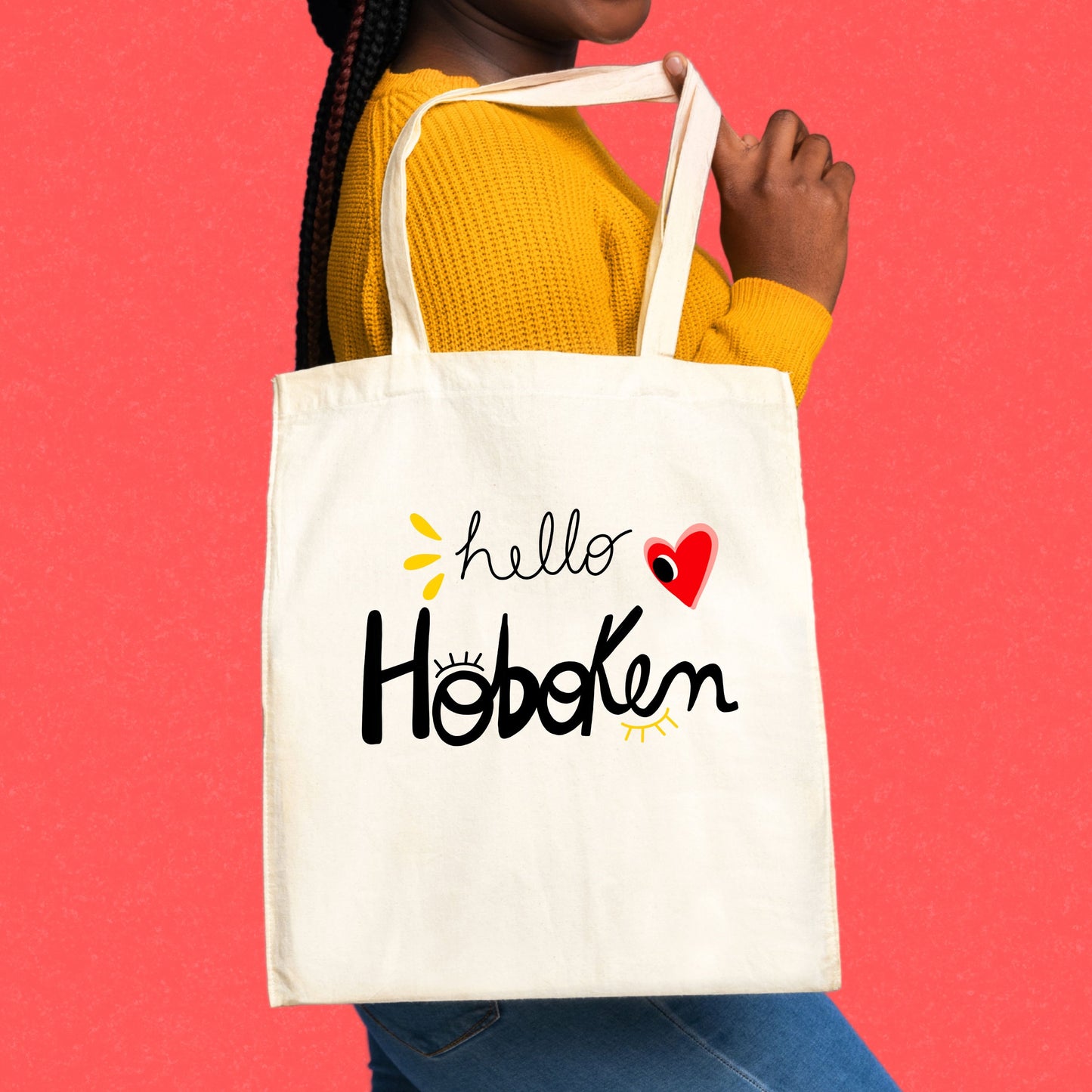 Tote bag with red heart and big eye design, called Hello Hoboken, representing Hoboken, New Jersey, perfect for stylish everyday use.