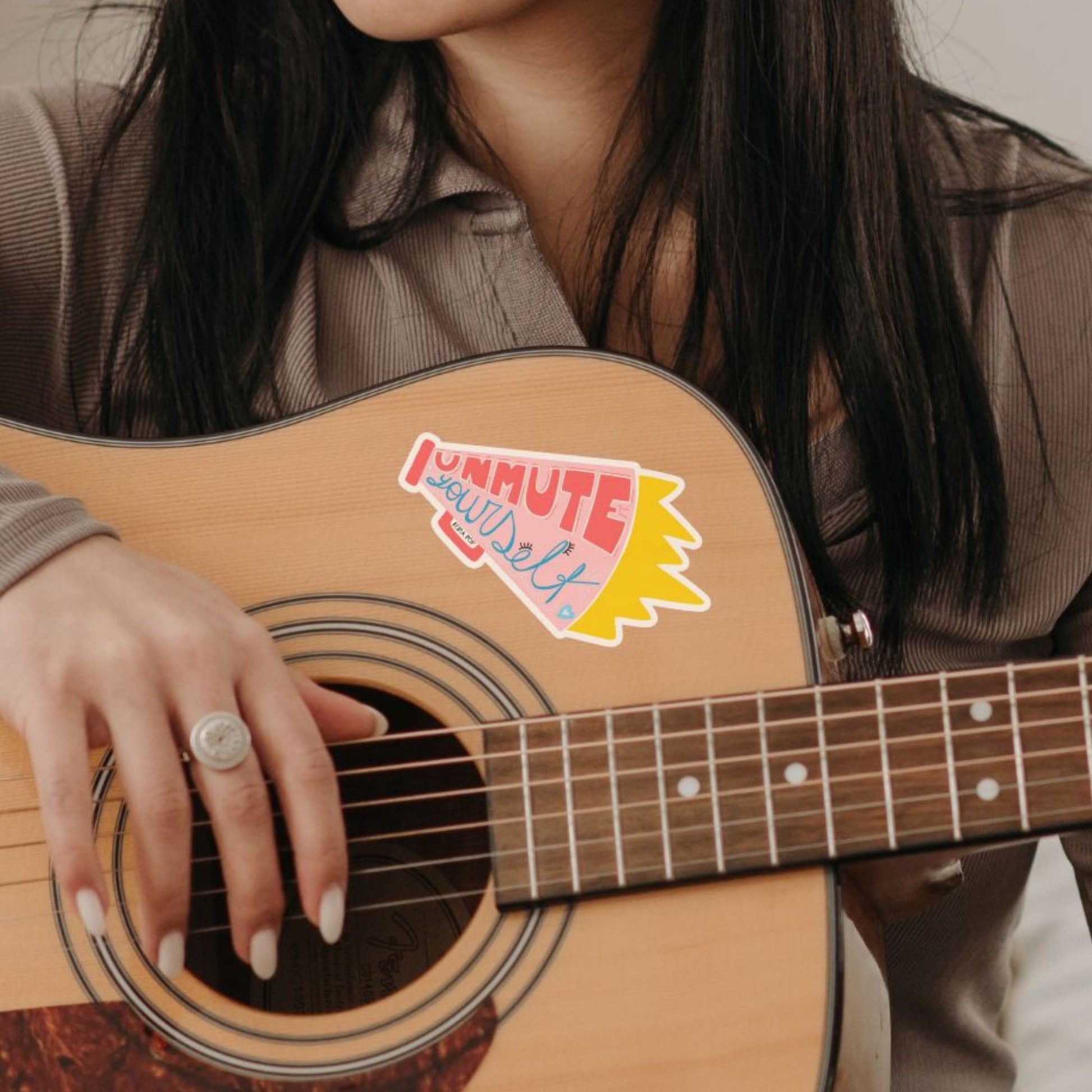 Unmute Yourself sticker with a pink megaphone design and the empowering phrase Unmute Yourself written inside.