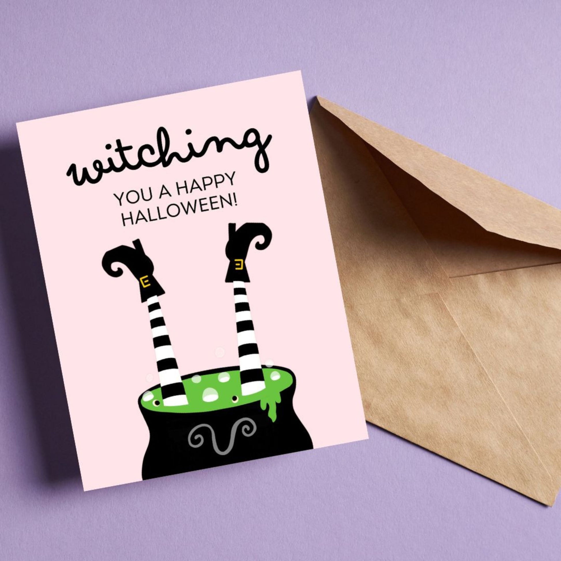 Halloween greeting card with a cauldron and two witch legs sticking out, featuring the phrase "Witching You A Happy Halloween," perfect for sending spooky and funny Halloween wishes.
