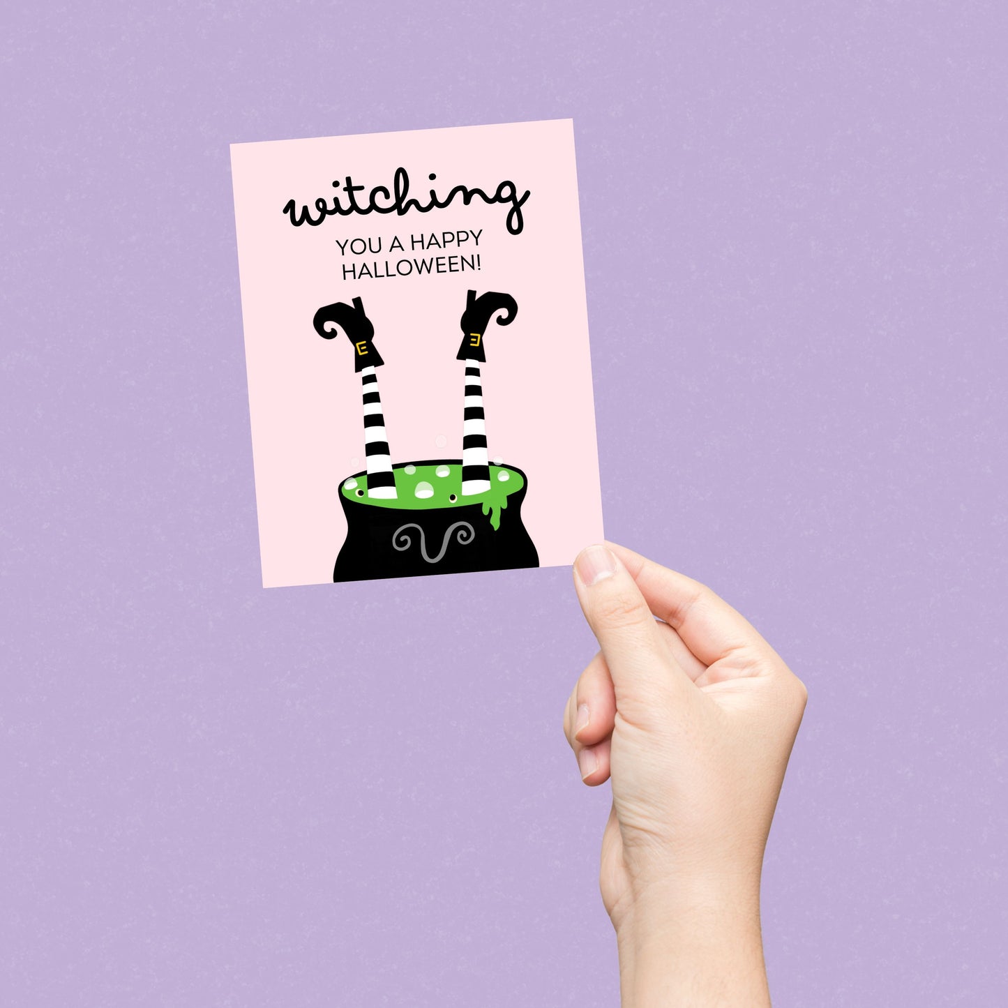 Halloween greeting card with a cauldron and two witch legs sticking out, featuring the phrase "Witching You A Happy Halloween," perfect for sending spooky and funny Halloween wishes.