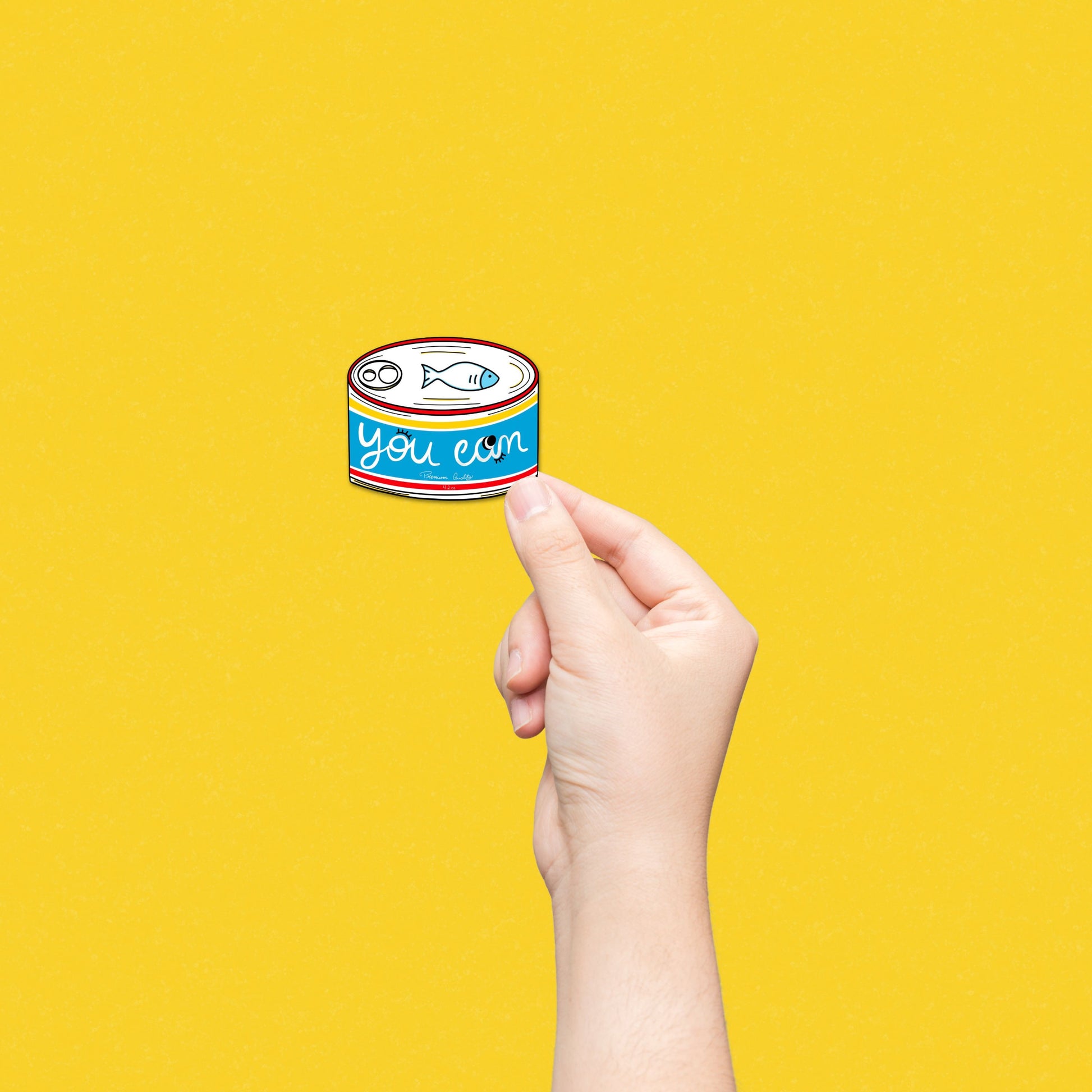 Blue tinned fish sticker with You Can written on it, serving as a quirky and motivational reminder for daily encouragement.