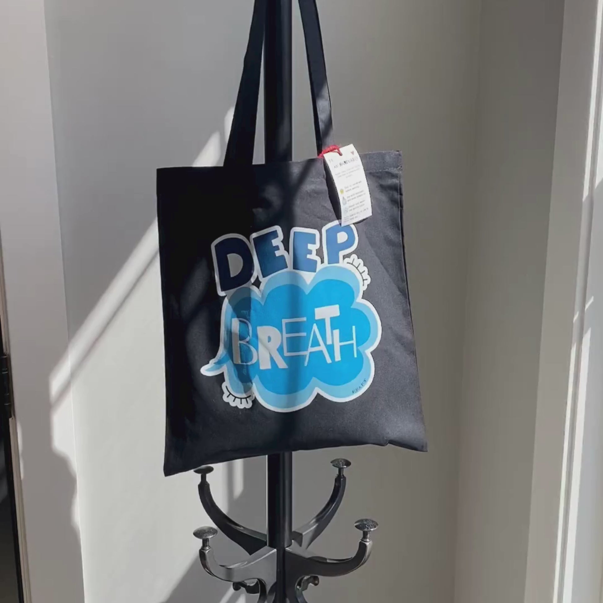 Deep Breath Tote Bag with original drawing of a serene cloud and the words Deep Breath written across it, perfect for carrying daily essentials and adding a touch of whimsy to your outfit.