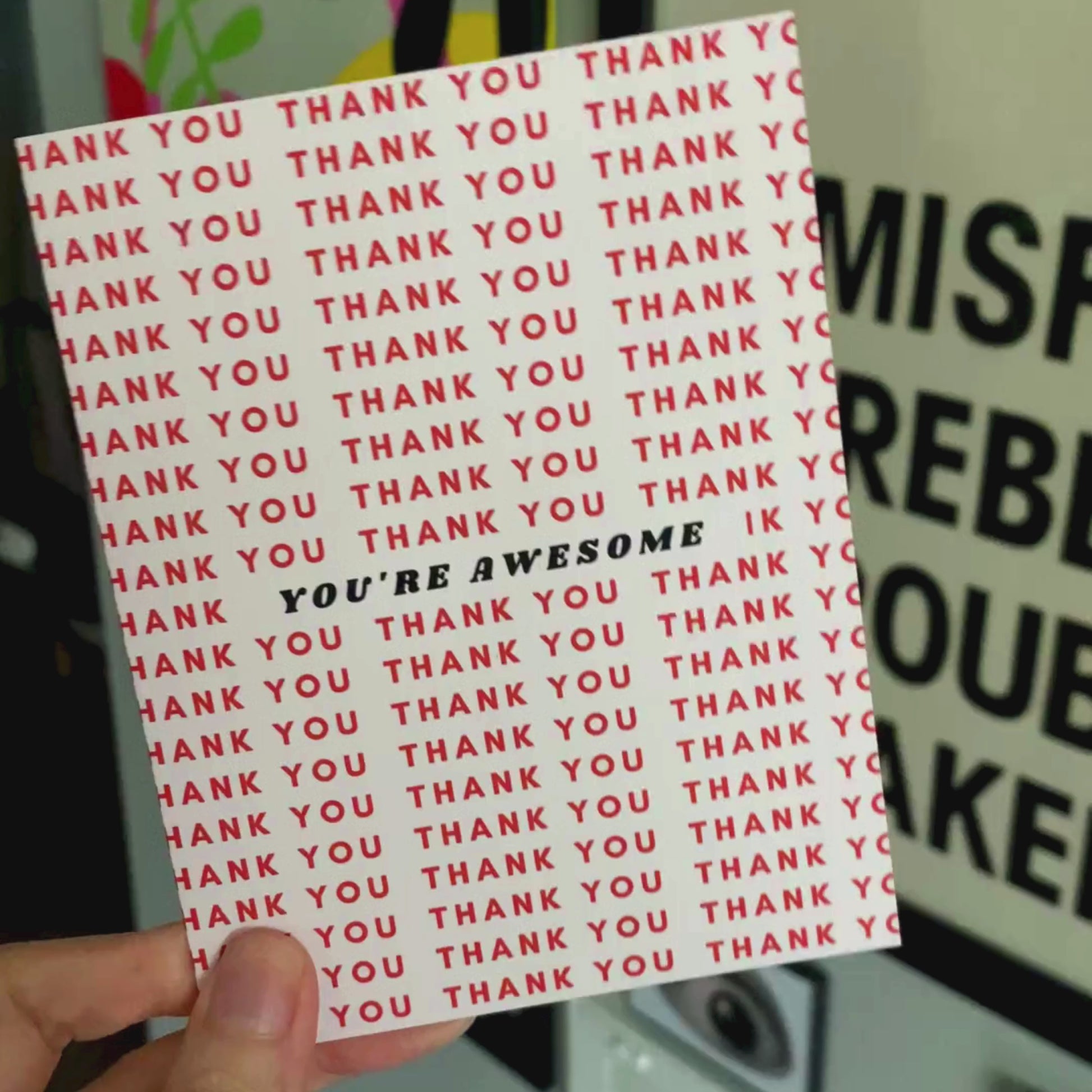Greeting card with a light pink background featuring Thank You written in red multiple times and You're Awesome in bold black letters at the center. Perfect for expressing gratitude with style.