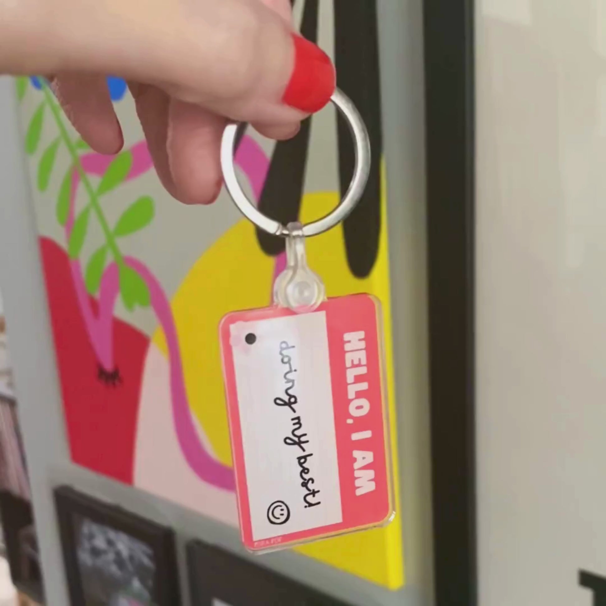 Red name tag keychain with the phrase Hello, I Am Doing My Best, humorous motivational accessory, perfect for daily encouragement and resilience, ideal gift for friends and family.