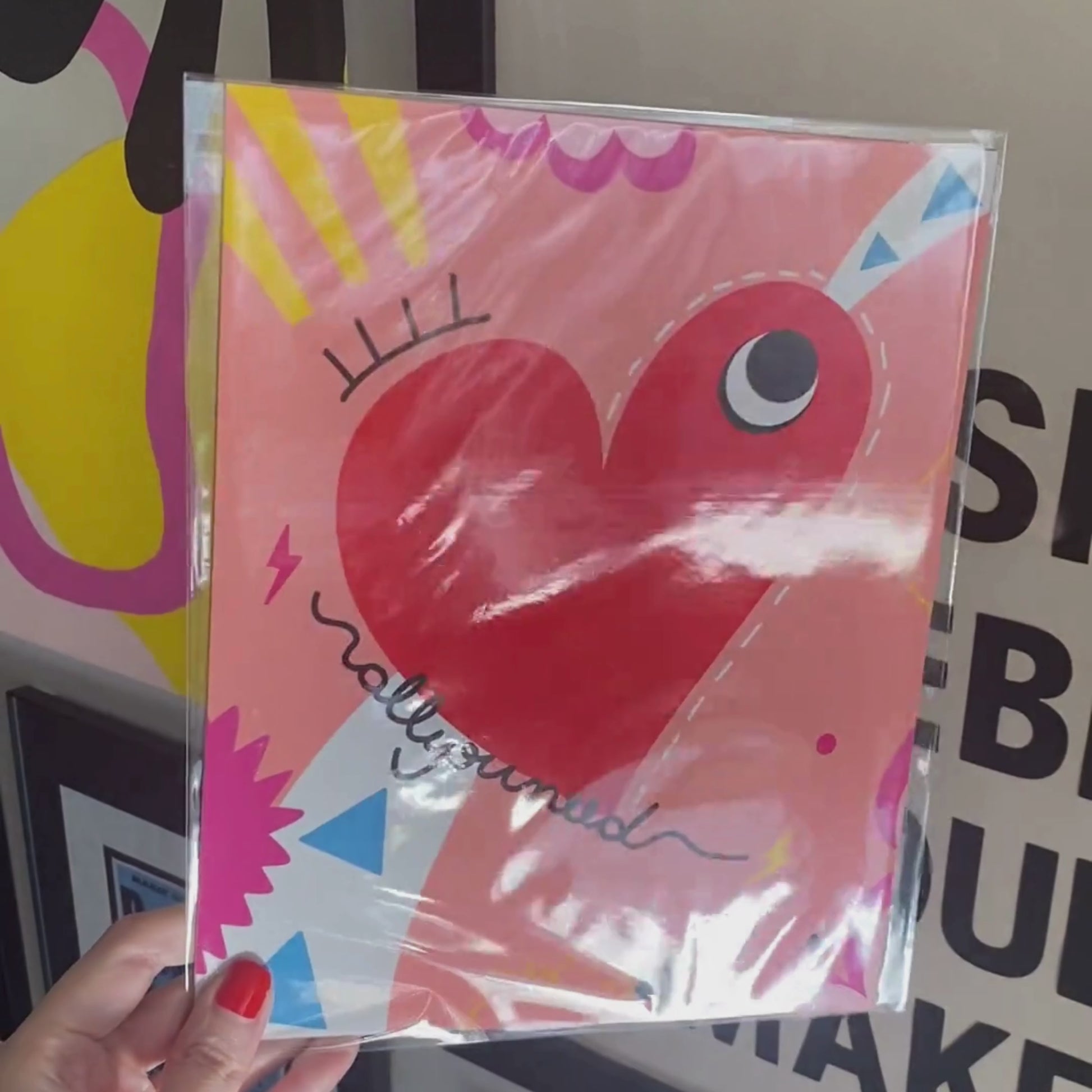 All You Need art print with an original drawing of a quirky red heart with one big eye, colorful background, adding a touch of whimsy and joy to any space.