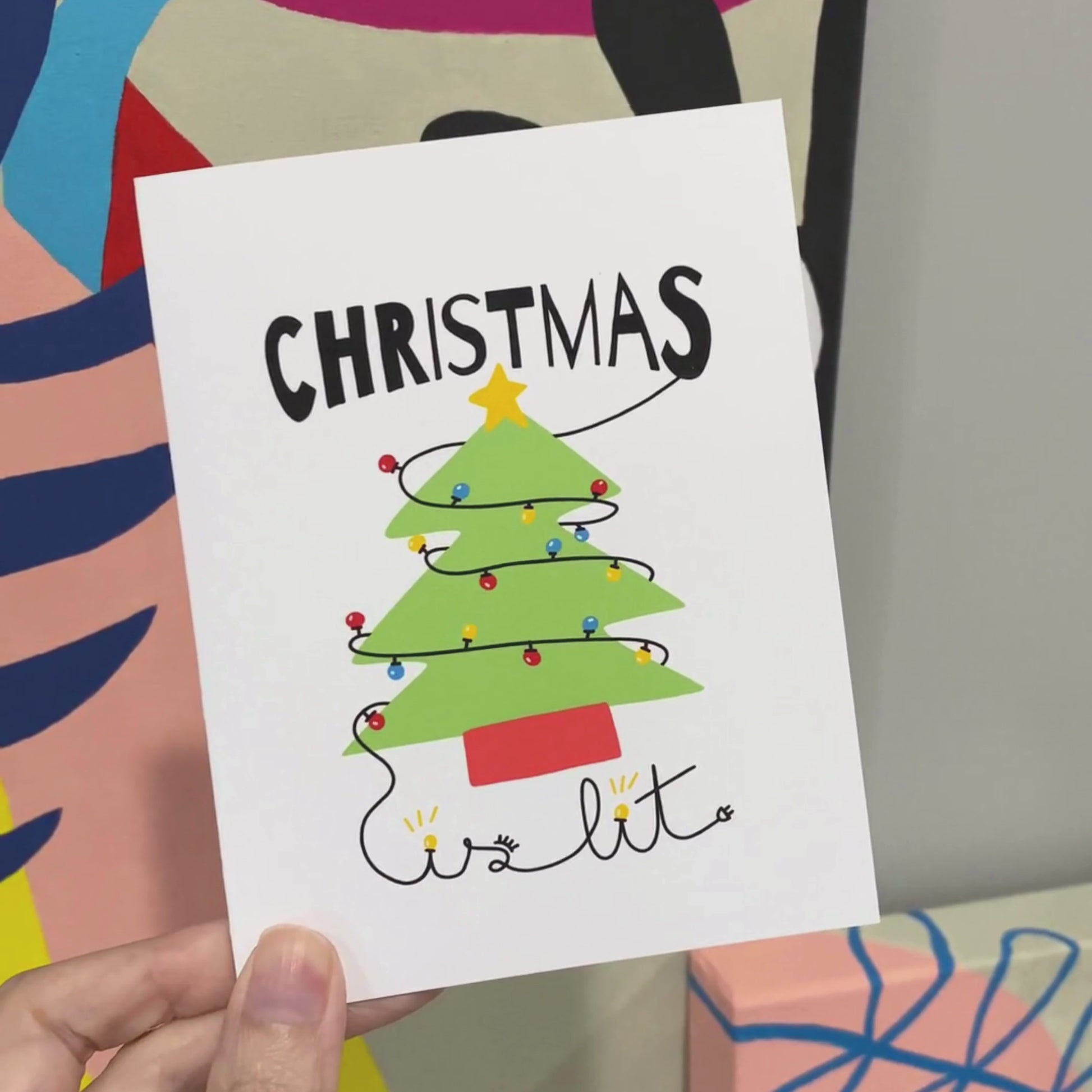 Christmas greeting card with the phrase Christmas is Lit featuring a drawing of a Christmas tree with colorful lights. Perfect for spreading festive cheer during the holiday season.