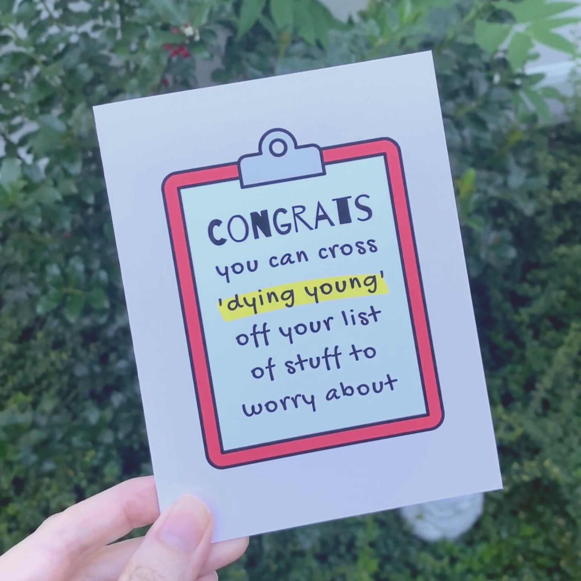 Humorous birthday card with a clipboard design and the phrase Congrats you can cross dying young off your list of stuff to worry about. Perfect for a funny and light-hearted birthday message, ideal for friends or family members with a sense of humor.