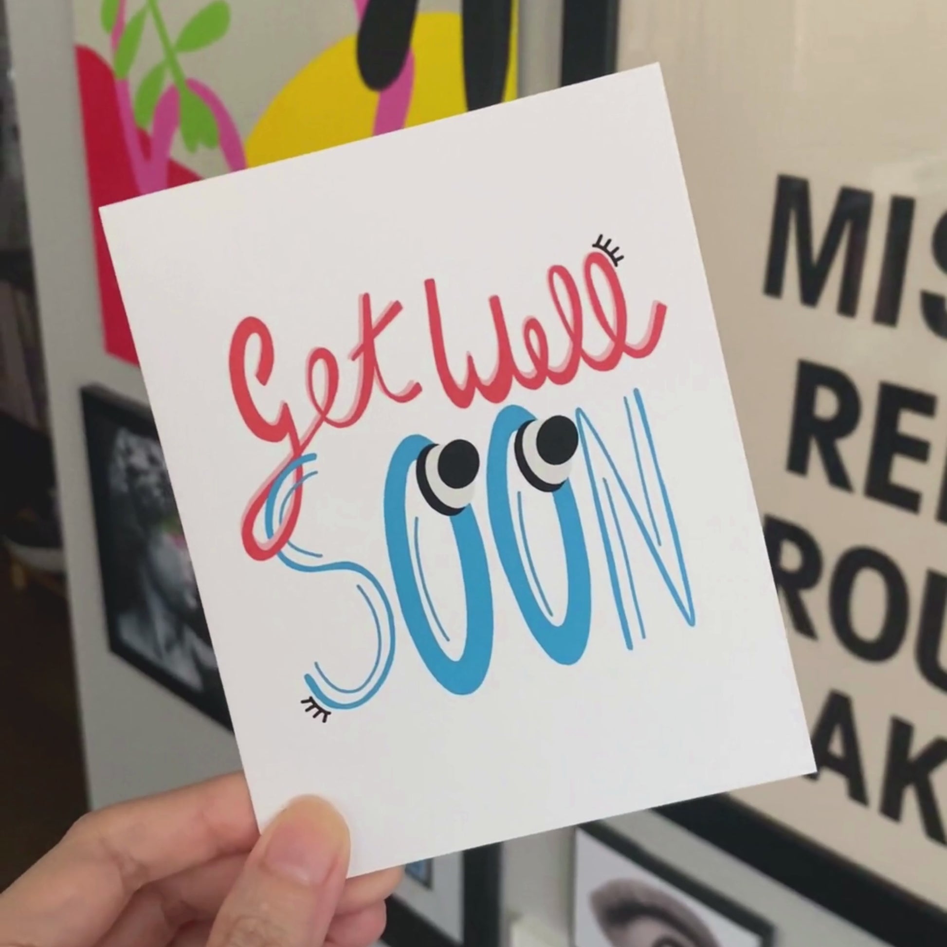 Greeting card with the phrase Get Well Soon featuring original lettering with two big googly eyes. Perfect for cheering up someone who is feeling under the weather with a playful and eye-catching touch.