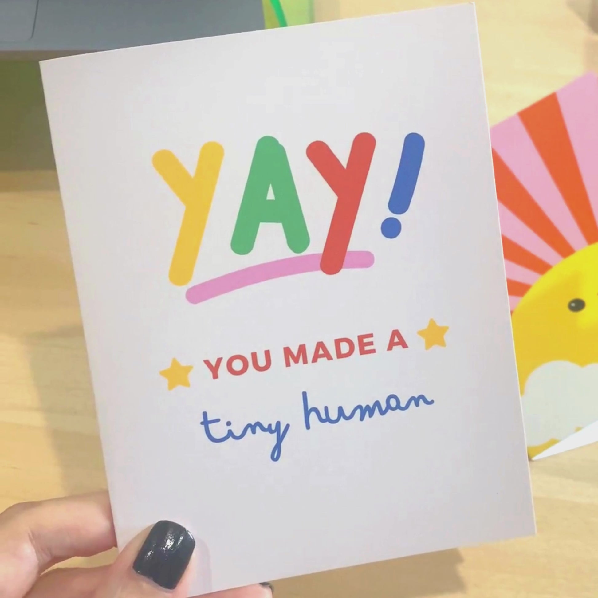 Yay You Made A Tiny Human greeting card with colorful letters and two stars, perfect for congratulating new parents.