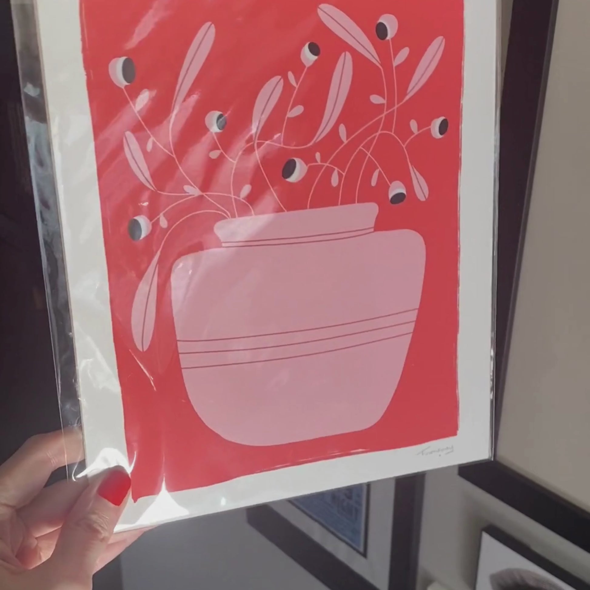 Nature Is Looking art print featuring an original drawing of a pink vase with a crazy plant with little eyes, set against a red background. Perfect for adding a touch of whimsy and humor to any space.