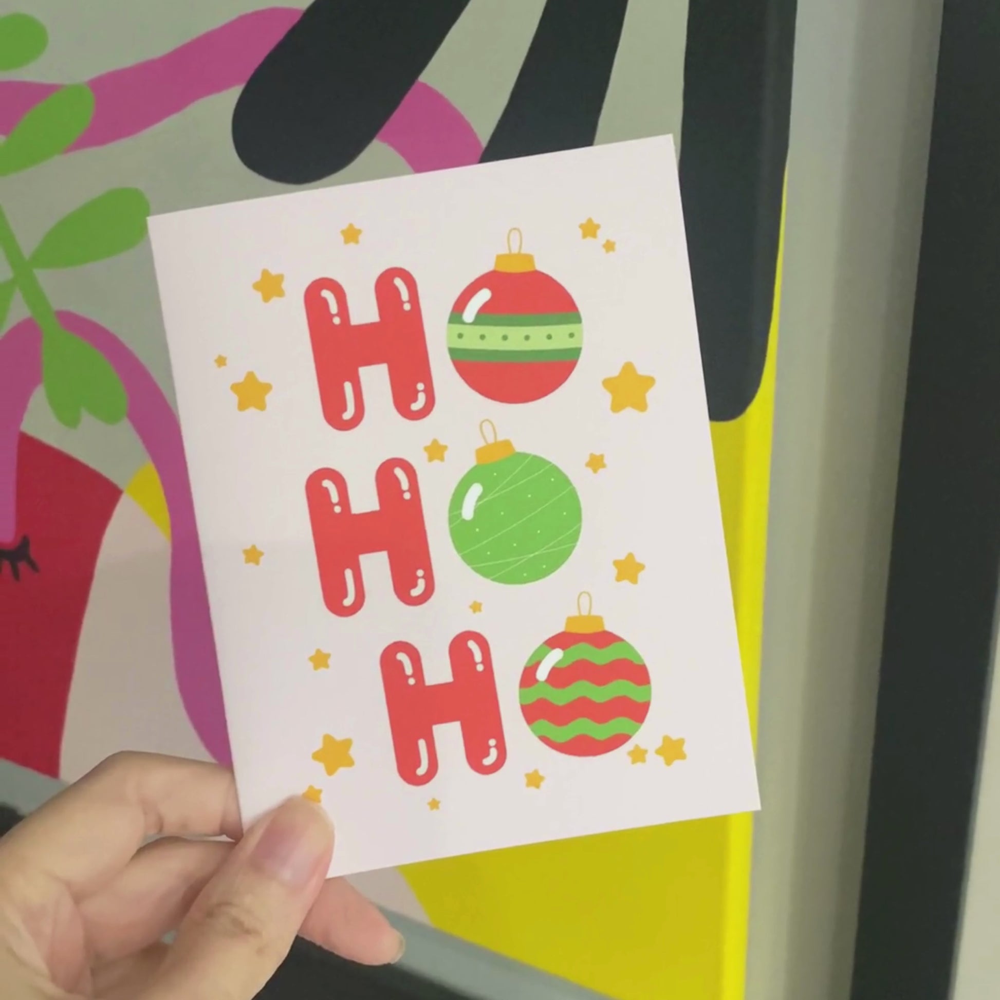 Christmas greeting card with the words 'Ho Ho Ho' featuring festive tree ornaments as the 'O's. The card has a playful holiday design perfect for spreading Christmas cheer. Ideal for sending warm wishes during the holiday season.