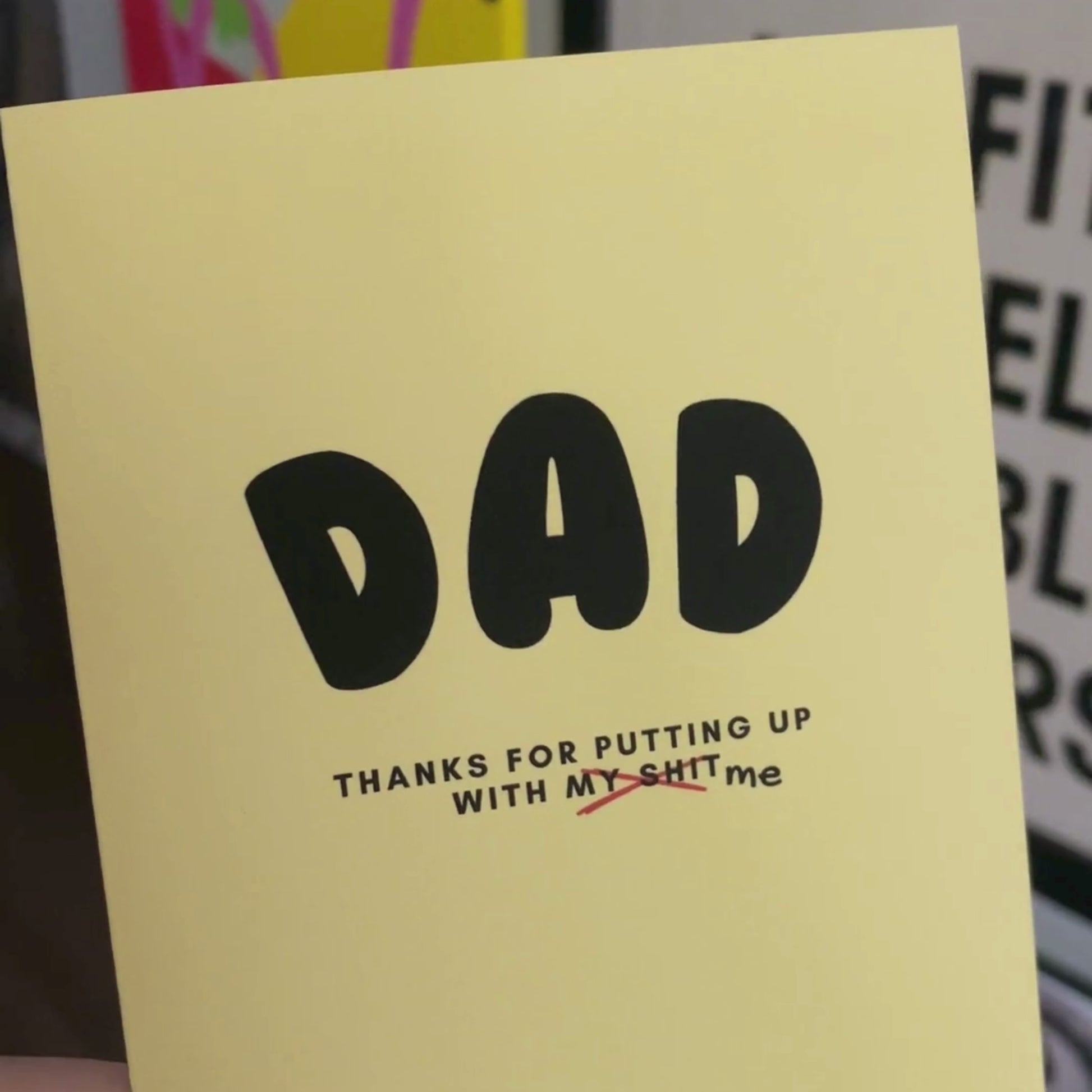 Greeting card with the phrase Dad, Thanks For Putting Up With My Shit in bold black letters on a yellow background. Perfect for showing appreciation to your dad with humor and heartfelt sentiment.