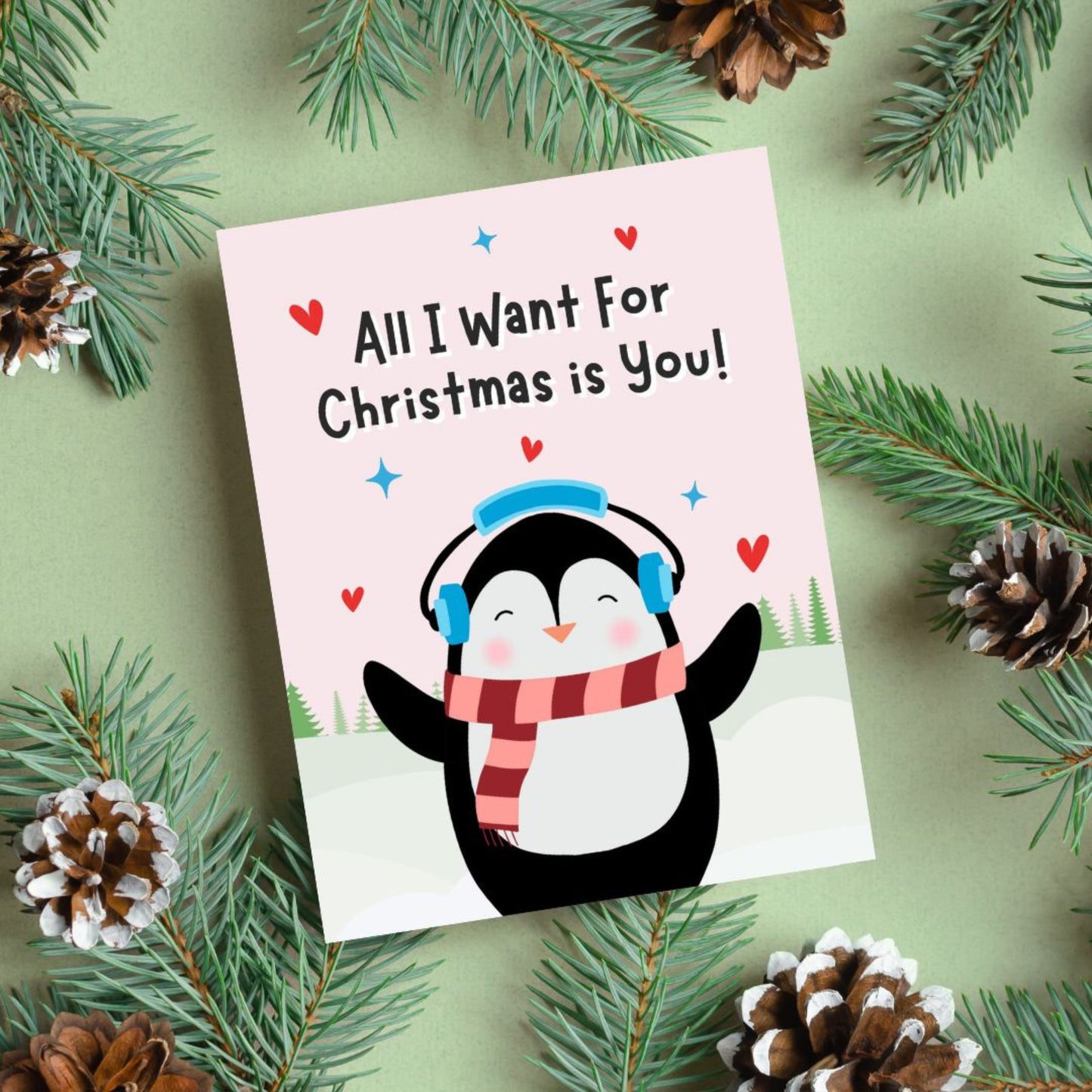 Cute Christmas card featuring an adorable penguin standing in a snowy winter scene with the phrase “All I Want For Christmas Is You.” Festive holiday card perfect for couples, romantic Christmas greetings, and seasonal gifting.