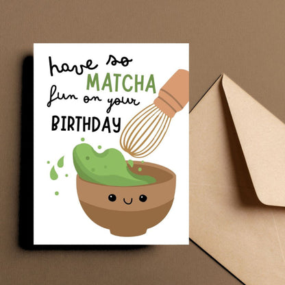 Cute birthday greeting card featuring a smiley matcha drink and the phrase Have So Matcha Fun On Your Birthday, perfect for tea lovers and pun enthusiasts.