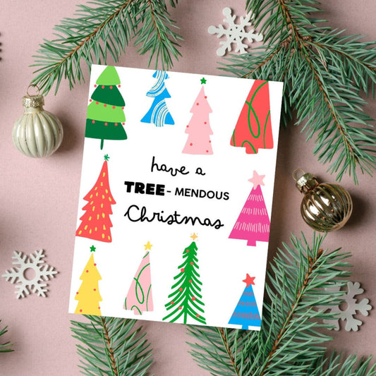 Have a Tree-mendous Christmas greeting card featuring a playful design of colorful Christmas trees and a festive phrase, perfect for spreading holiday cheer and sending fun, pun-filled holiday wishes to loved ones.