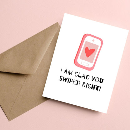 Funny dating anniversary card with a cute phone with a heart on the screen, and the phrase "I Am Glad You Swiped Right." Perfect for couples who met on a dating app, this love card is great for Valentine's Day, anniversaries, or just because.