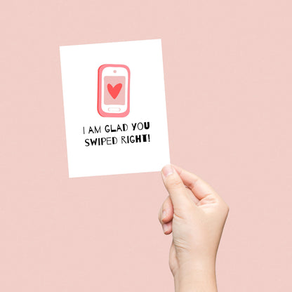 Funny dating anniversary card with a cute phone with a heart on the screen, and the phrase "I Am Glad You Swiped Right." Perfect for couples who met on a dating app, this love card is great for Valentine's Day, anniversaries, or just because.