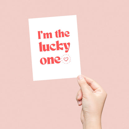 Greeting card with bold red letters and the phrase "I'm The Lucky One" with a small heart, perfect for anniversaries, Valentine's Day, or expressing love and appreciation.