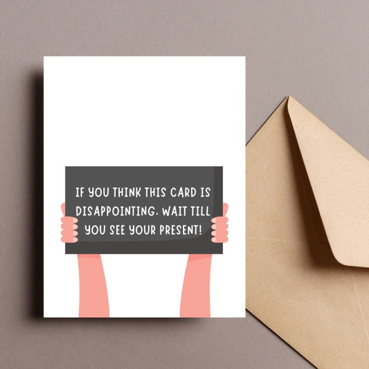 Funny greeting card with two illustrated arms holding a sign that reads If You Think This Card Is Disappointing, Wait Till You See Your Present. Perfect for adding humor to birthdays, holidays, or any special occasion.