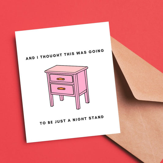 Greeting card with the phrase And I Thought This Was Going to Be a Night Stand featuring an illustration of a pink nightstand with two drawers. Perfect for celebrating relationships with a humorous and cheeky touch.